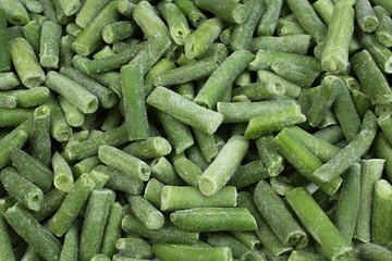 frozen chopped asparagus beans. top view. background green wax beans.