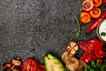 Grilled vegetables on black background. Diet vegan food.