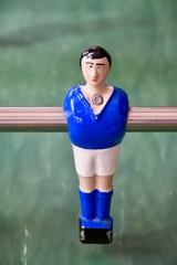 Table football player in blue outfit.