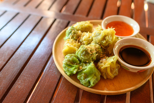 Yellow And Green Dumpling Dim Sum Stuffed With Pork And Shrimp With Sauces