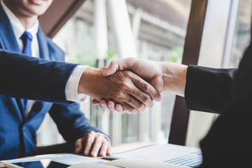 Handshake of two business people after contract agreement to become partner