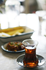 Tea in traditional turkish glass on a table