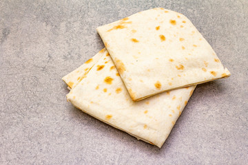 Pita bread lavash on a stone background. Food cooking background, wallpaper.