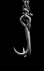 old metall chain hook on black background