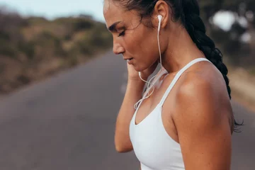 Foto op Canvas Sportswoman listening to music while jogging © Jacob Lund