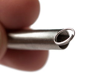 Metal spring in hand isolated on white background