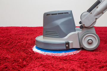 Red shaggy carpet chemical foaming, rubbing and cleaning with professionally disk machine. General or regular cleanup. Commercial cleaning company concept. Close up. Side view. 