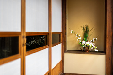 Traditional japanese house or ryokan with shoji sliding paper doors and ikebana decoration