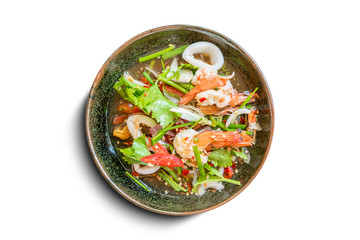 Healthy salad plate. Fresh seafood recipe, shrimps and fresh vegetable salad and hot chili source on traditional dish isolate on white background.