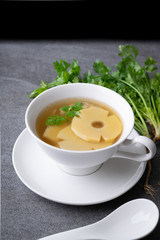 Bamboo shoot soup or bamboo shoot boiled with pork in white bowl on the concrete table background.