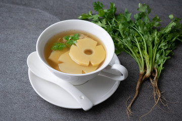Bamboo shoot soup or bamboo shoot boiled with pork in white bowl on the concrete table background.