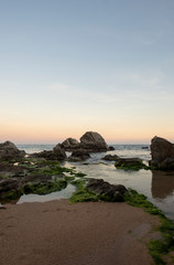 Fototapeta na wymiar Beach and rocks at sunset in Lloret de Mar