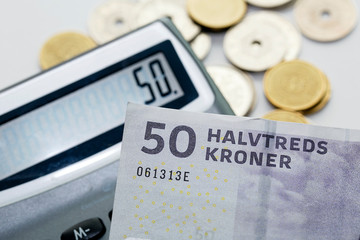 Fifty Krone note over a calculator - Krone is the official currency of Denmark. 