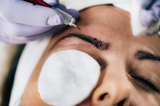 Microblading Eyebrows in Beauty Salon.