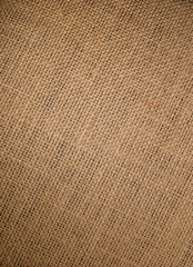 Jute hessian sackcloth canvas woven texture pattern background with natural gradienten light