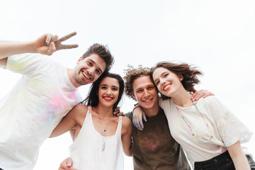 Group of a cheerful young friends having fun at the beach