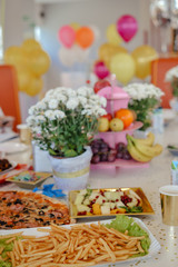 Fast food. Pizza birthday party in cafe with balloons