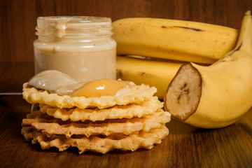 closeup spoon with tahini and honey on belgian waffles
