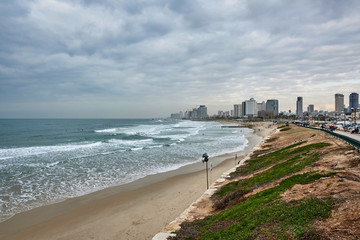 Israel. Tel Aviv. Winter beach. Surfers