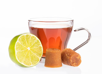 Fresh homemade Aguapanela, Agua de Panela or Aguadulce, a popular Latin American sweet drink made of panela unrefined whole cane sugar boiled in water, served warm or cold with lime.