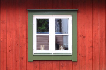 Fototapeta na wymiar White window in a red wooden wall