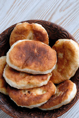 Potato pies on a ceramic dish top view