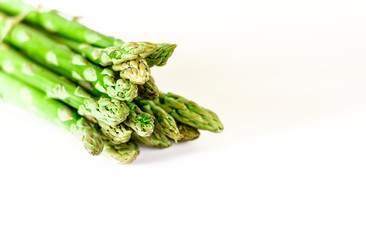 Food background asparagus flat lay pattern. bunch of fresh green asparagus on white background, top view.