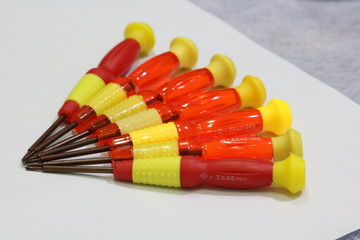 small red-yellow screwdrivers on table