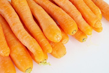 ripe orange carrots close-up on a white background