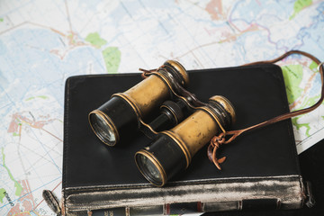 Ancient binoculars lie on book