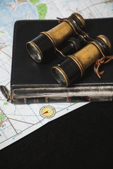 Ancient binoculars lie on book