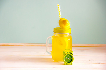 Drink for weight loss based on citrus fruits, orange, lemon and lime in a transparent glass with a straw - Powered by Adobe