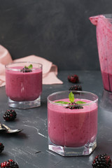 Protein cocktail with cottage cheese and blackberries is located in glasses on a dark background