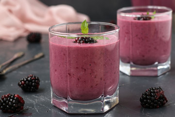 Protein cocktail with cottage cheese and blackberries is located in glasses on a dark background