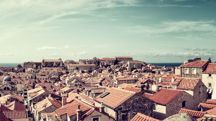 Fototapeta na wymiar Dubrovnik Old City red tiled roofs, panoramic view from the ancient city wall, scenic cityscape. World famous and most visited historic city of Croatia, UNESCO World Heritage site, travel background