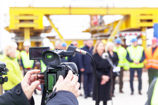 Press conference. Filming media event with a video camera.