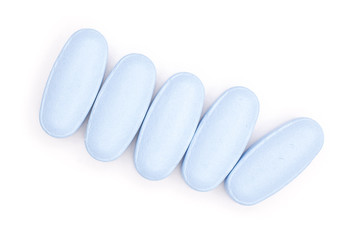 Group of five whole blue medical drug flatlay isolated on white background
