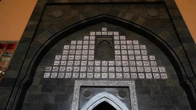 Wide still shot of Jamia Masjid-Srinagar compound, its magnificent building and minarets, walking paths, green grass garden, and people, Srinagar-India.