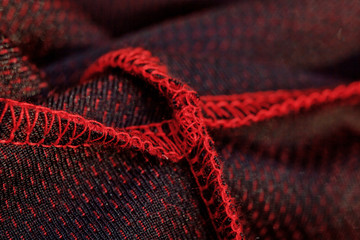 red sportswear closeup top view. seam and juncture inside out. breathable knitwear. clothing details macro