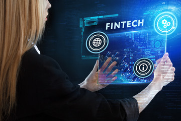 The concept of business, technology, the Internet and the network. A young entrepreneur working on a virtual screen of the future and sees the inscription: Fintech