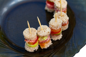 Delicious appetizer canapes of black bread, and vegetables