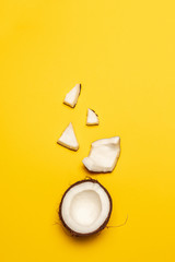 Tropical abstract coconut pattern on yellow background. Flat lay.