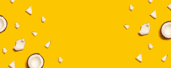 Pattern with ripe coconuts on yellow background. Flat lay.