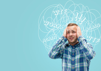 Young caucasian man with mixed thoughts against blue background. Negative space to insert your text. Concept of thinking confusion, stress out, misunderstanding, facial expression, human emotions.