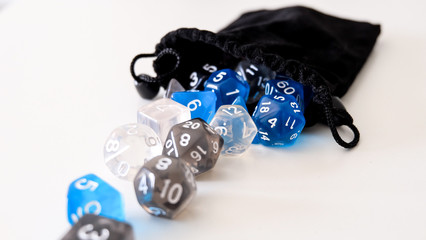 A set of dices for board games and roleplay games falling out of the bag