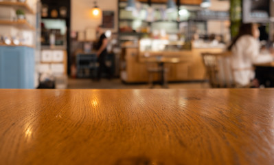 A brown table in a coffee shop with blurred background