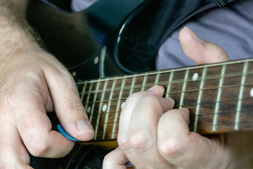 Fototapeta na wymiar Close-up of man playing lead guitar solo