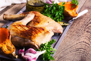 Grilled chicken legs, roasted pumpkin, pesto sauce and fresh parsley