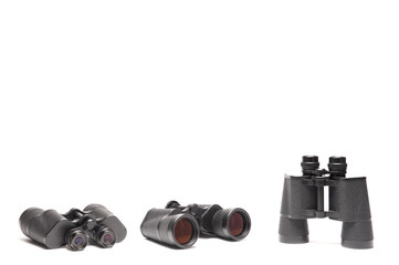 Three angles of vintage binoculars isolated on white background