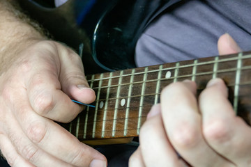 Fototapeta na wymiar Close-up of man playing lead guitar solo